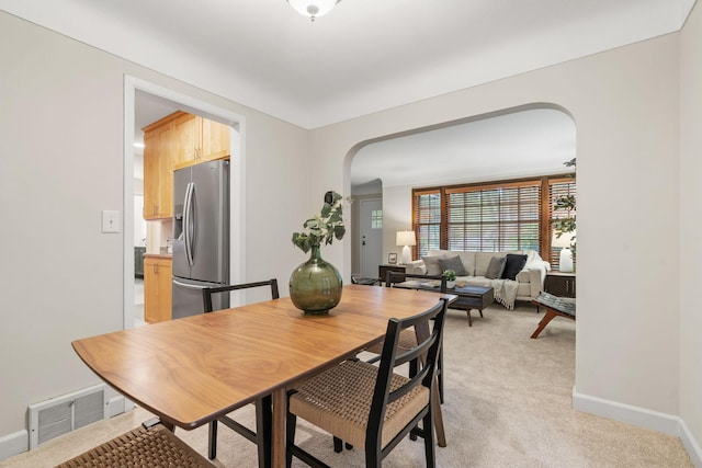 2709 Ewing Ave N, Robbinsdale, MN 55422 - dining space featuring arched walkways and light carpet