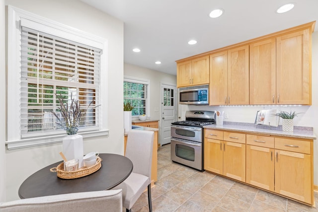 2709 Ewing Ave N, Robbinsdale, MN 55422 - kitchen featuring appliances with stainless steel finishes, light brown cabinetry, recessed lighting, and light stone finish floors