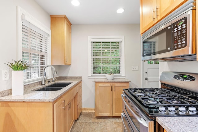 2709 Ewing Ave N, Robbinsdale, MN 55422 - kitchen featuring appliances with stainless steel finishes, light brown cabinetry, light stone counters, and recessed lighting