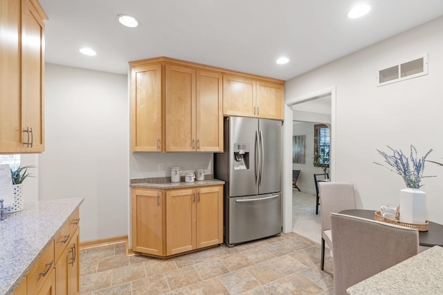 2709 Ewing Ave N, Robbinsdale, MN 55422 - kitchen featuring stainless steel refrigerator with ice dispenser, light brown cabinets, light stone finish flooring, recessed lighting, and light stone counters