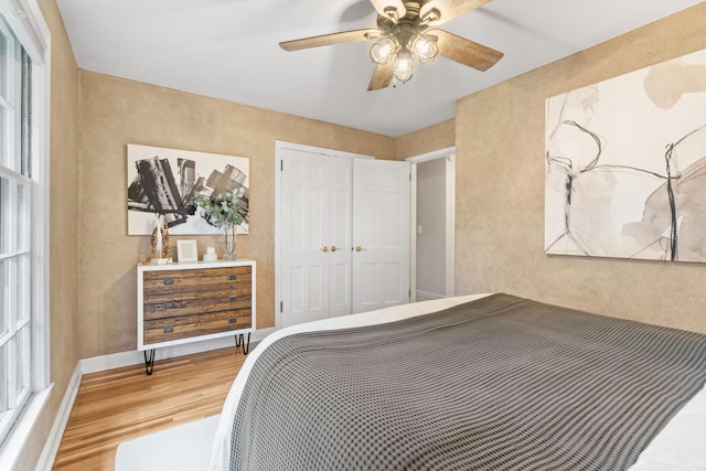 2709 Ewing Ave N, Robbinsdale, MN 55422 - bedroom with wood finished floors, a closet, and a ceiling fan