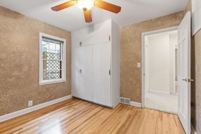 2709 Ewing Ave N, Robbinsdale, MN 55422 - unfurnished bedroom with light wood-style flooring, a closet, and a ceiling fan