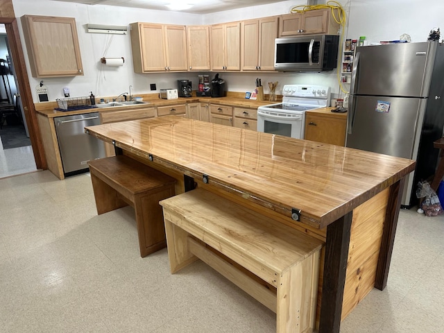 200 Park Ave, Williams, MN 56686 - kitchen featuring stainless steel appliances, butcher block countertops, light floors, and light brown cabinets