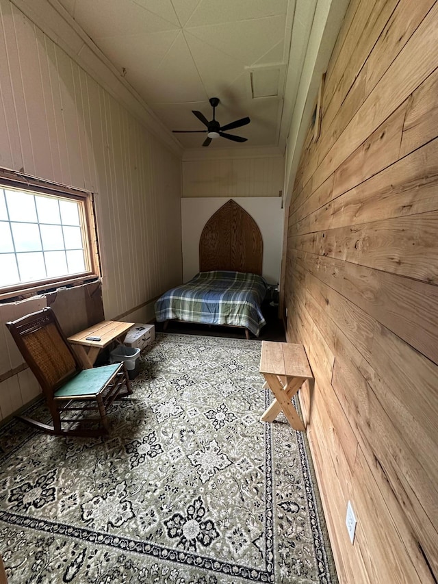 200 Park Ave, Williams, MN 56686 - bedroom with wooden walls, tile patterned floors, ornamental molding, and a ceiling fan