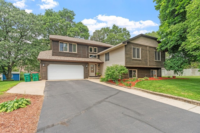 13048 Jay St NW, Coon Rapids, MN 55448 - view of front of house with asphalt driveway, an attached garage, and a front yard
