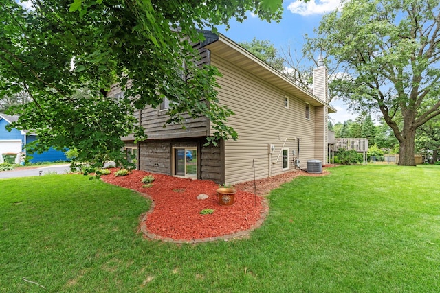 13048 Jay St NW, Coon Rapids, MN 55448 - view of home's exterior featuring a lawn and a chimney
