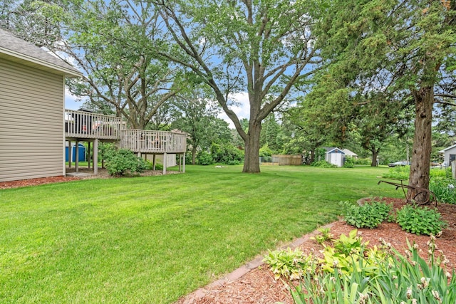 13048 Jay St NW, Coon Rapids, MN 55448 - view of green lawn featuring a storage unit and a deck
