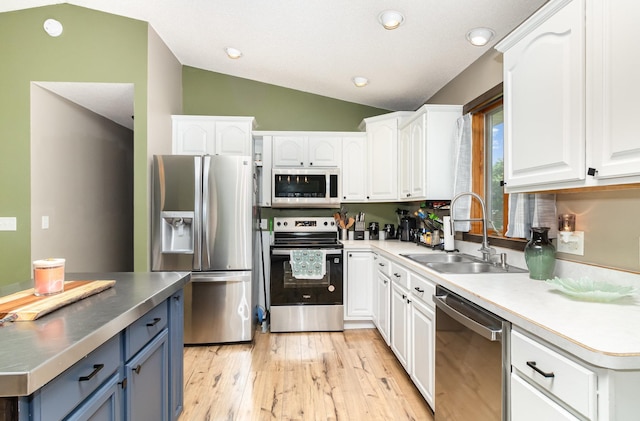 204 Sidney St E, Morristown, MN 55052 - kitchen featuring appliances with stainless steel finishes, white cabinetry, vaulted ceiling, light wood-style floors, and recessed lighting