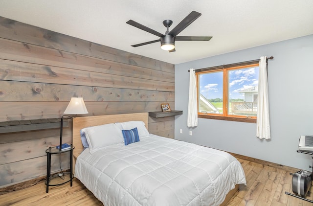 204 Sidney St E, Morristown, MN 55052 - bedroom with wood walls, wood finished floors, and ceiling fan
