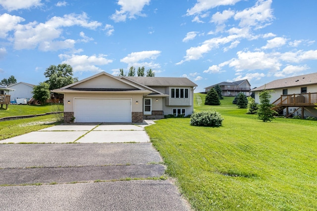 204 Sidney St E, Morristown, MN 55052 - view of front of home featuring an attached garage, asphalt driveway, brick siding, and a front lawn