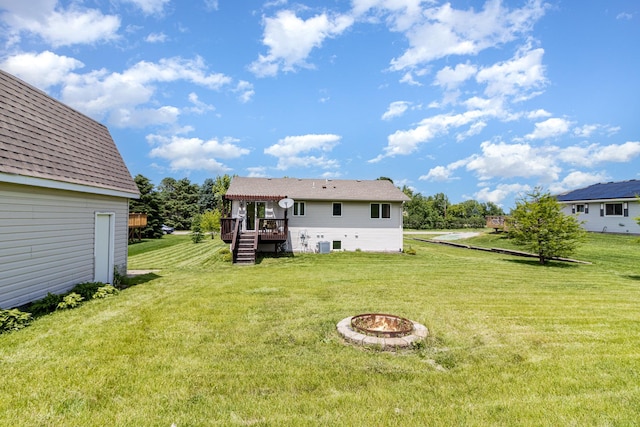 204 Sidney St E, Morristown, MN 55052 - back of property featuring a deck, an outdoor fire pit, stairway, and a yard