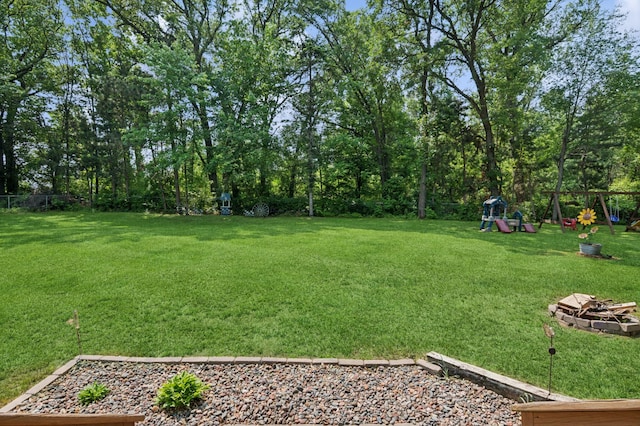 2796 269th Ave NE, Isanti, MN 55040 - view of yard with a playground and an outdoor fire pit