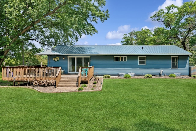 2796 269th Ave NE, Isanti, MN 55040 - back of house with a wooden deck, a metal roof, and a lawn