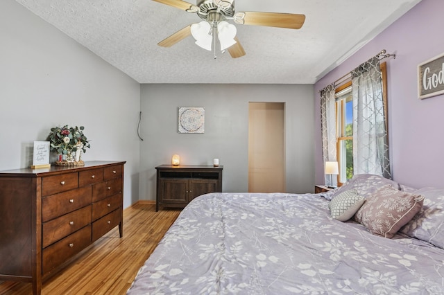 2796 269th Ave NE, Isanti, MN 55040 - bedroom featuring light wood finished floors, a textured ceiling, and a ceiling fan