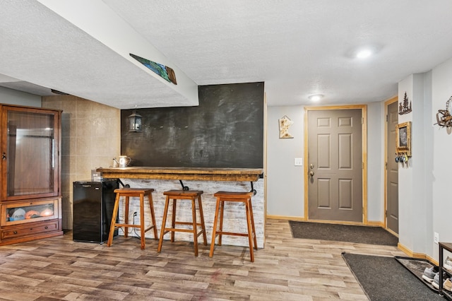 2796 269th Ave NE, Isanti, MN 55040 - kitchen with a textured ceiling, wood finished floors, and freestanding refrigerator