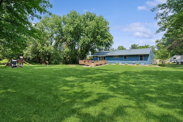 2796 269th Ave NE, Isanti, MN 55040 - view of green lawn with a deck and a playground
