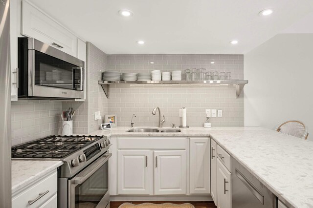 5713 Duncan Ln, Edina, MN 55436 - kitchen with appliances with stainless steel finishes, open shelves, decorative backsplash, white cabinets, and recessed lighting