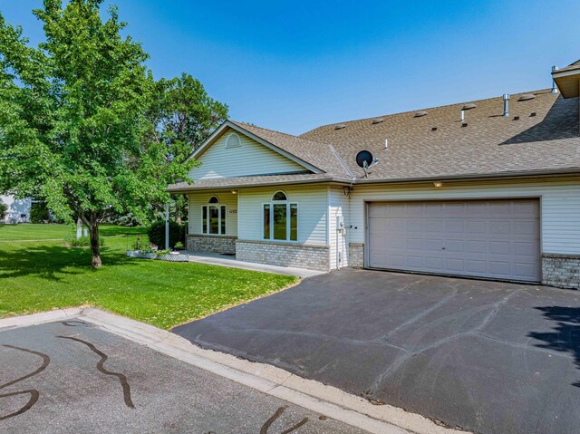 1152 Crystal Pl W, Chaska, MN 55318 - view of front of house featuring driveway, a front lawn, brick siding, an attached garage, and roof with shingles