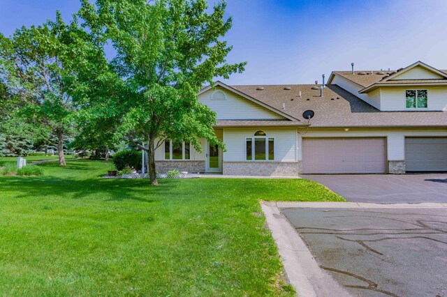 1152 Crystal Pl W, Chaska, MN 55318 - view of front facade with driveway, roof with shingles, a front lawn, a garage, and brick siding