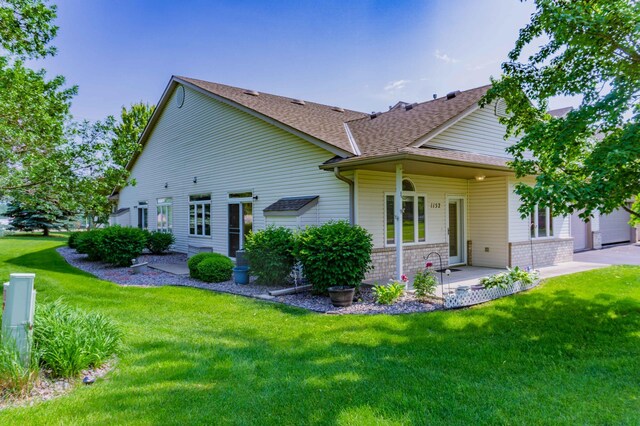 1152 Crystal Pl W, Chaska, MN 55318 - rear view of house featuring a shingled roof, a lawn, and a patio