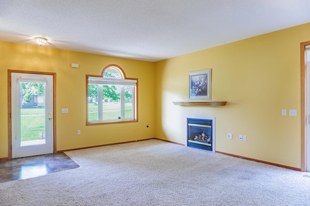 1152 Crystal Pl W, Chaska, MN 55318 - unfurnished living room with carpet, a glass covered fireplace, and a textured ceiling