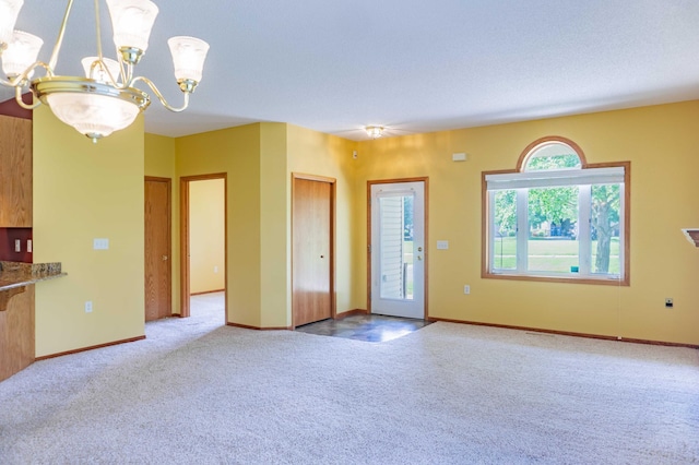 1152 Crystal Pl W, Chaska, MN 55318 - unfurnished living room featuring light colored carpet and a chandelier