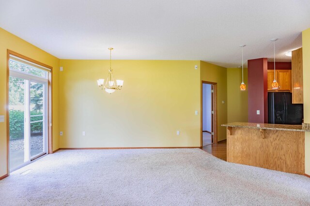 1152 Crystal Pl W, Chaska, MN 55318 - kitchen featuring black refrigerator with ice dispenser, carpet, a chandelier, decorative light fixtures, and a peninsula