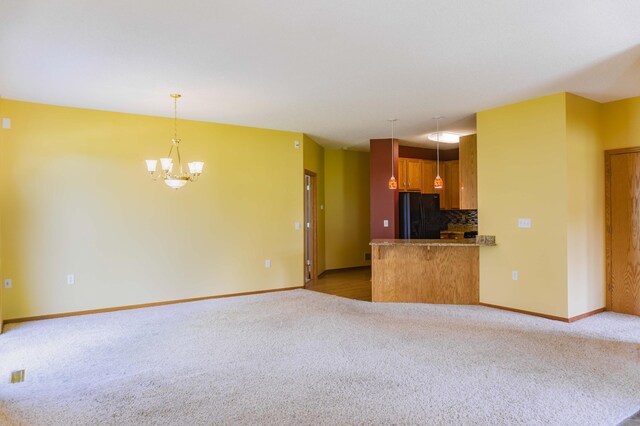 1152 Crystal Pl W, Chaska, MN 55318 - kitchen with freestanding refrigerator, light carpet, decorative backsplash, open floor plan, and a chandelier