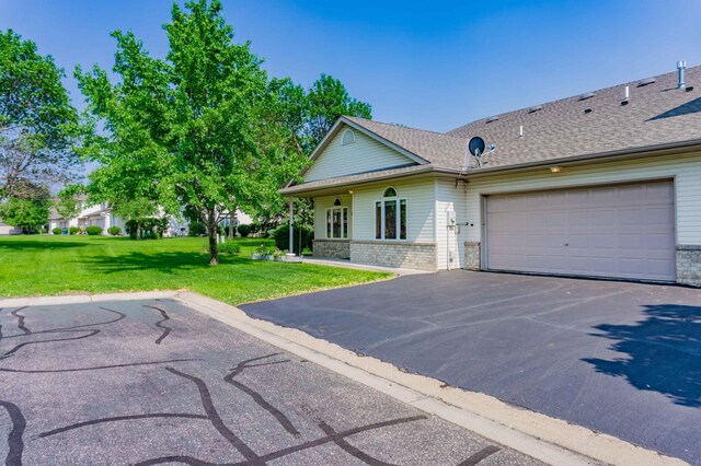 1152 Crystal Pl W, Chaska, MN 55318 - view of front of property with driveway, brick siding, a front yard, an attached garage, and a shingled roof