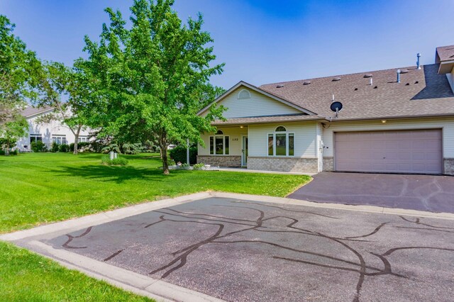 1152 Crystal Pl W, Chaska, MN 55318 - view of front of property with brick siding, a front yard, asphalt driveway, and roof with shingles