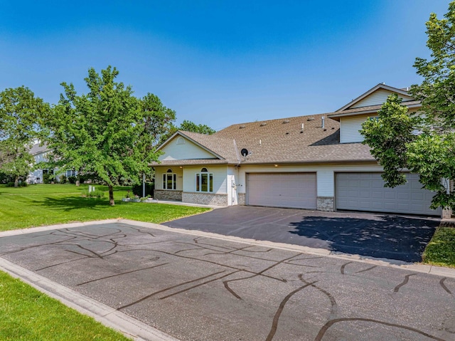 1152 Crystal Pl W, Chaska, MN 55318 - view of front of house with asphalt driveway, a front lawn, a shingled roof, an attached garage, and stone siding