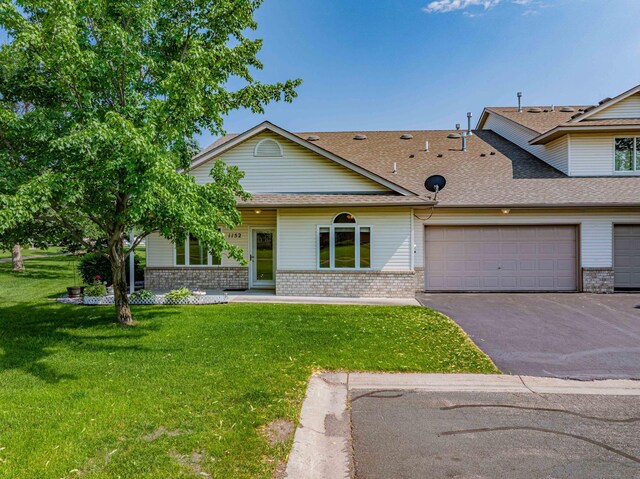 1152 Crystal Pl W, Chaska, MN 55318 - view of front of property with brick siding, driveway, roof with shingles, a front yard, and a garage