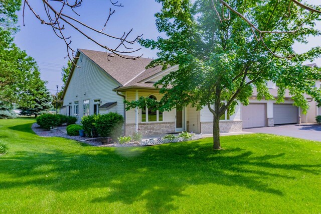 1152 Crystal Pl W, Chaska, MN 55318 - view of front of house with brick siding, a front lawn, driveway, and roof with shingles