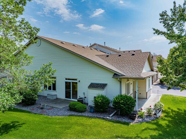 1152 Crystal Pl W, Chaska, MN 55318 - back of house featuring roof with shingles, a patio, and a lawn