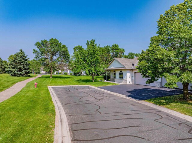 1152 Crystal Pl W, Chaska, MN 55318 - view of front of house featuring an attached garage, driveway, and a front lawn