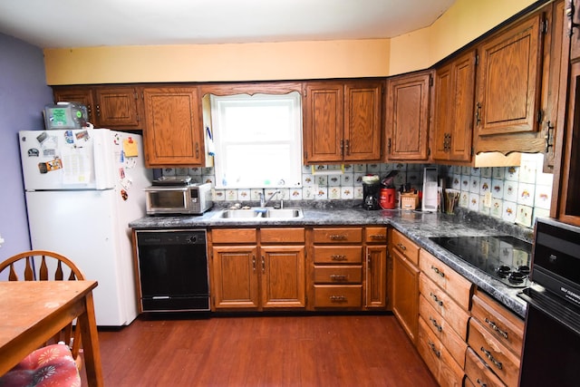 145 Riverside Dr, Stephen, MN 56757 - kitchen with black appliances, dark wood-type flooring, dark countertops, brown cabinets, and backsplash