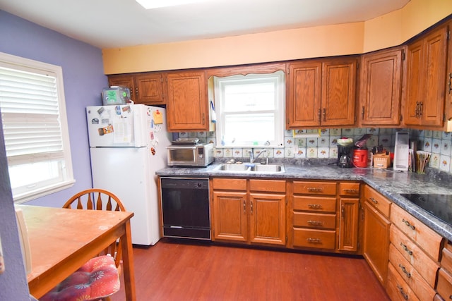 145 Riverside Dr, Stephen, MN 56757 - kitchen featuring black appliances, brown cabinets, dark wood finished floors, dark countertops, and tasteful backsplash