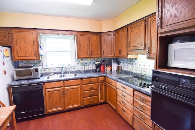 145 Riverside Dr, Stephen, MN 56757 - kitchen with black appliances, dark wood finished floors, brown cabinetry, dark countertops, and backsplash