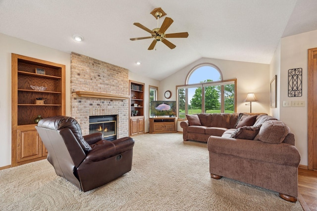 2771 County Line Ave, Osceola, WI 54020 - living room with ceiling fan, vaulted ceiling, a fireplace, built in features, and light colored carpet