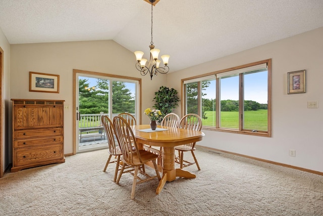 2771 County Line Ave, Osceola, WI 54020 - dining area featuring a chandelier, plenty of natural light, carpet floors, a textured ceiling, and vaulted ceiling