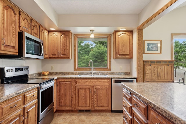 2771 County Line Ave, Osceola, WI 54020 - kitchen featuring stainless steel appliances and brown cabinets