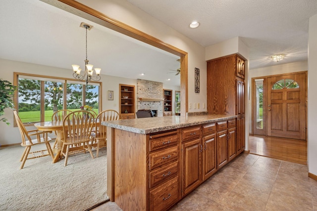 2771 County Line Ave, Osceola, WI 54020 - kitchen with brown cabinetry, plenty of natural light, light countertops, and a textured ceiling
