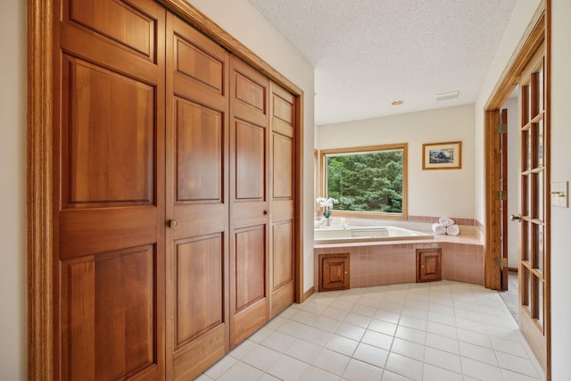 2771 County Line Ave, Osceola, WI 54020 - bathroom featuring a bath, a textured ceiling, and tile patterned floors