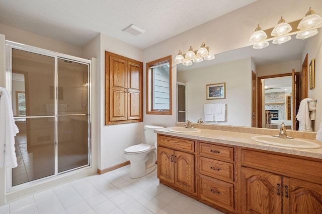 2771 County Line Ave, Osceola, WI 54020 - full bath with double vanity, a stall shower, tile patterned flooring, a fireplace, and a textured ceiling