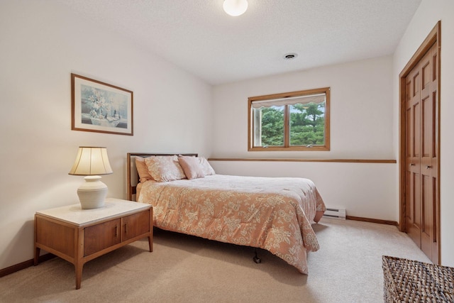 2771 County Line Ave, Osceola, WI 54020 - bedroom featuring light colored carpet, a closet, and baseboard heating