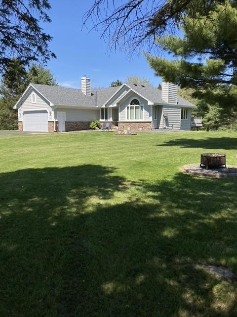 2771 County Line Ave, Osceola, WI 54020 - view of green lawn featuring a garage