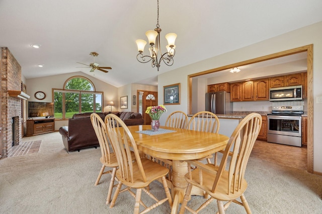 2771 County Line Ave, Osceola, WI 54020 - dining room with light colored carpet, lofted ceiling, a ceiling fan, a chandelier, and a fireplace
