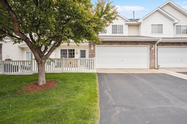 3307 Coleshire Path Unit 14, Rosemount, MN 55068 - view of front of home featuring asphalt driveway, stone siding, a garage, and roof with shingles