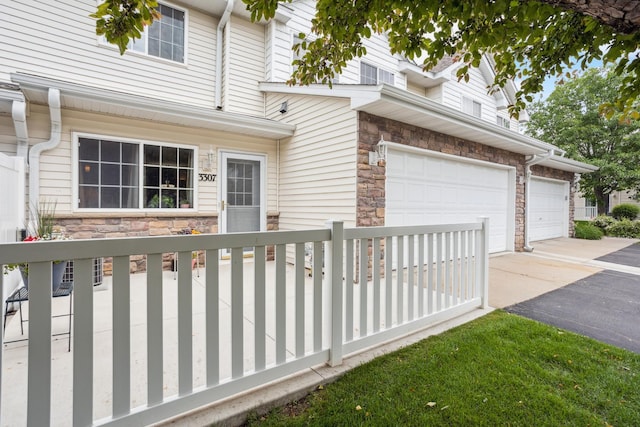3307 Coleshire Path Unit 14, Rosemount, MN 55068 - view of front facade featuring stone siding, driveway, and a garage