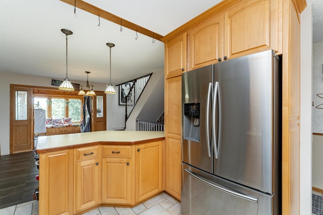 510 24th St SW, Rochester, MN 55902 - kitchen featuring stainless steel fridge with ice dispenser, a peninsula, light countertops, pendant lighting, and light tile patterned floors